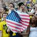 Michigan fans hold up an American flag in the stands at Michigan Stadium on Saturday. Melanie Maxwell I AnnArbor.com